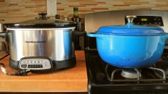 A slow cooker and a Dutch oven in a kitchen side by side.