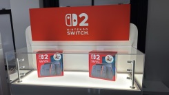 two switch 2 boxes in a display case